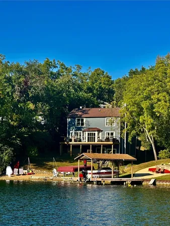 an aerial view of a house with swimming pool patio and lake view