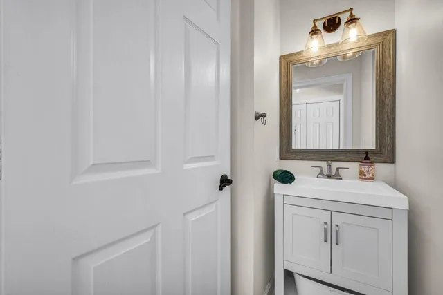 a bathroom with a sink mirror and vanity