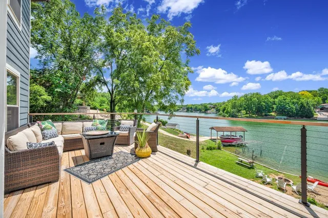 a view of balcony with wooden floor and outdoor seating
