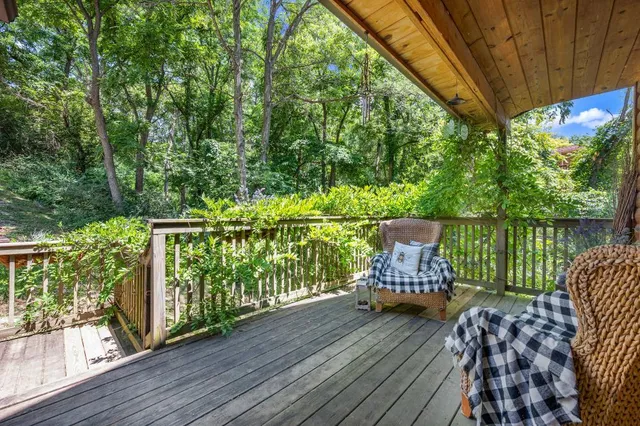 a view of a deck with furniture and garden