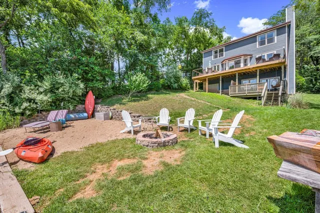 a view of a chairs and table in backyard of the house
