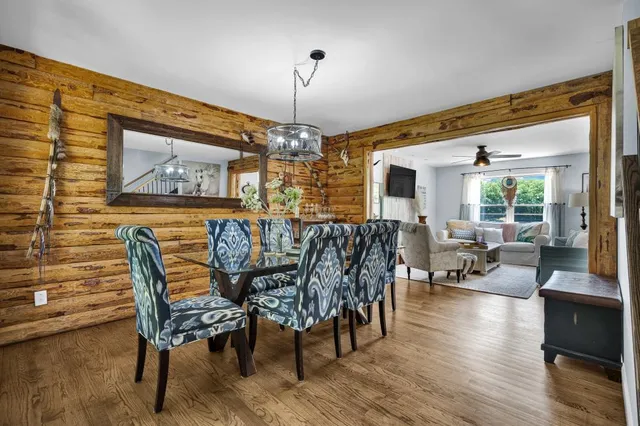 a view of a dining room with furniture window and wooden floor