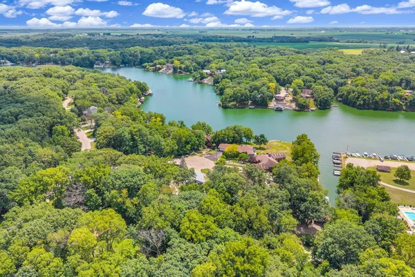 an aerial view of a houses with a lake view