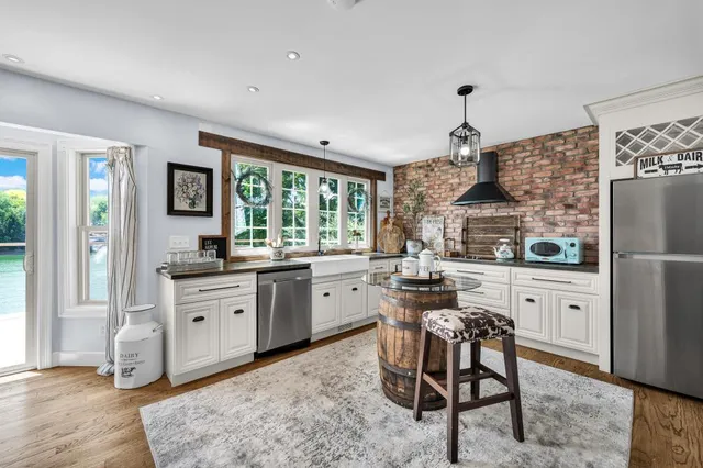 a kitchen with granite countertop appliances cabinets and a dining table