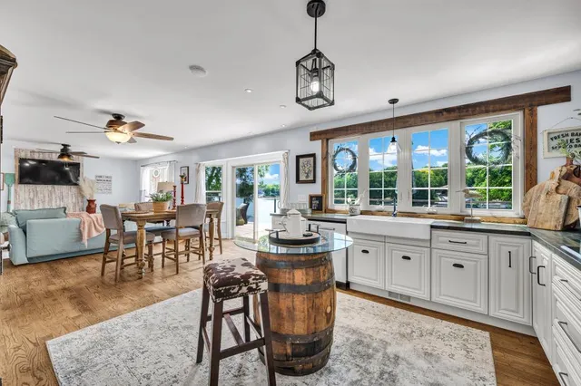 a very nice looking living room with a dining table and a large window with garden view