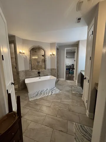 a bathroom with a glass door shower