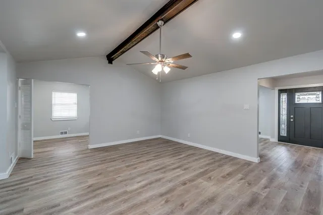 wooden floor in an empty room with a window
