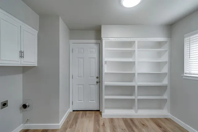 a view of walk in closet with empty racks