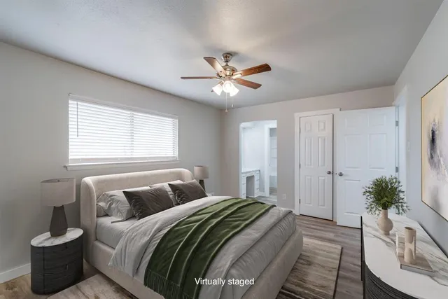 a bedroom with a bed and a potted plant