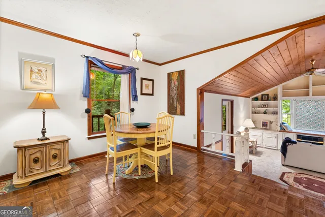 a dining room with furniture and wooden floor