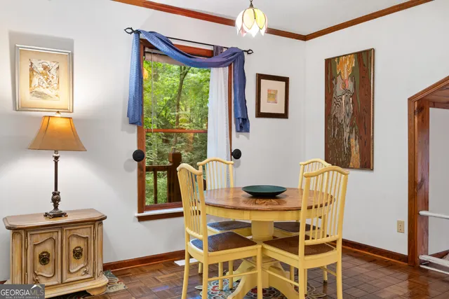 a view of a dining room with furniture window and wooden floor