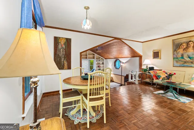 a dining room with furniture and wooden floor