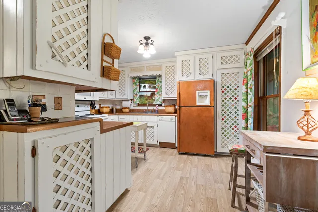 a kitchen with stainless steel appliances granite countertop a refrigerator and stove