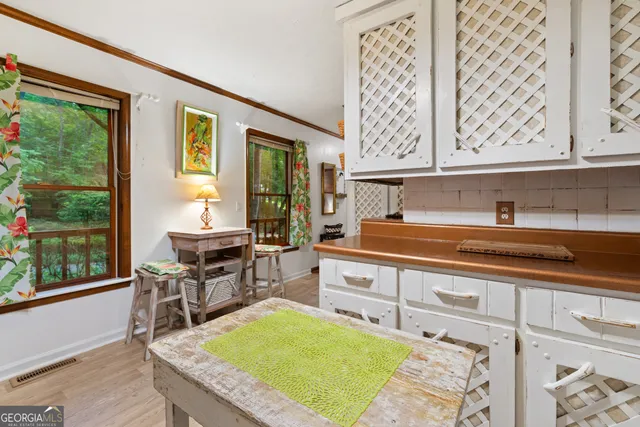 a kitchen with a stove a sink and a wooden cabinets