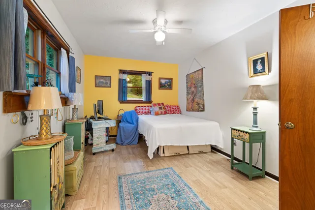 a spacious bedroom with a bed table and a couch