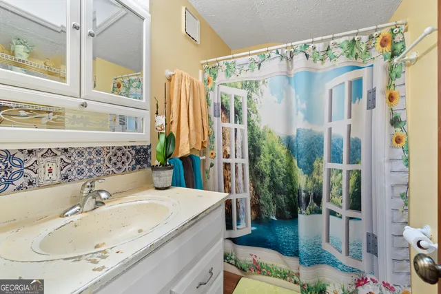 a bathroom with a tub sink and mirror