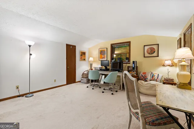 an aerial view of a house with yard and sitting area