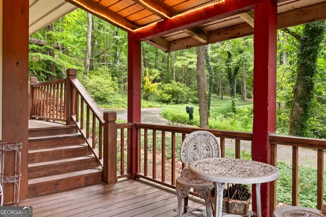 a view of a two chairs and table in the deck