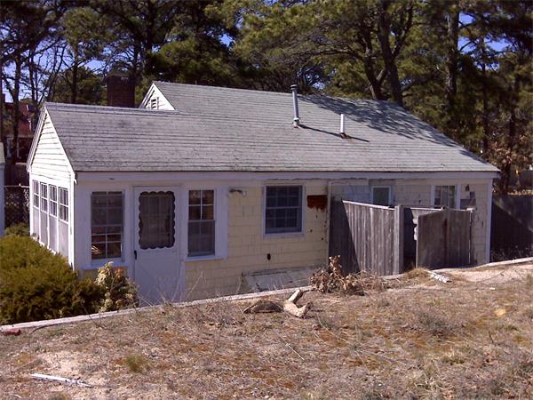 36 Edwards Road Dennis, MA 02639 - Photo 3 of 8 a view of a house with wooden fence and a tree