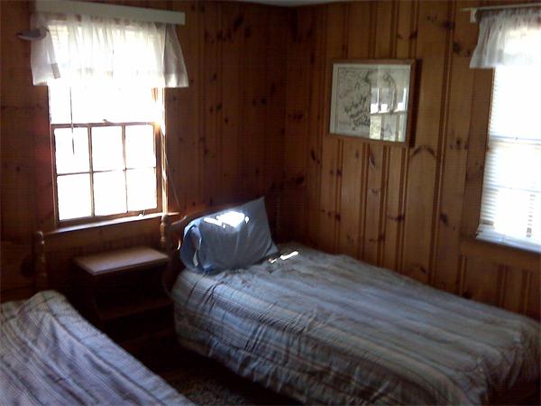 36 Edwards Road Dennis, MA 02639 - Photo 5 of 8 a bedroom with a bed and wooden floor