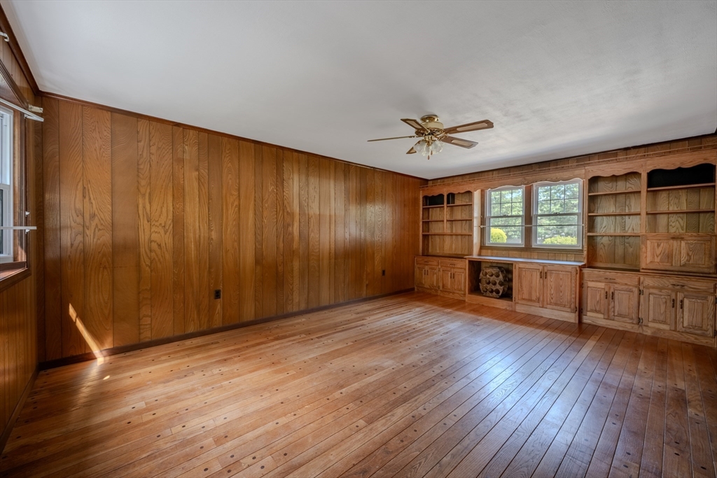 10 Primrose Road Billerica, MA 01821 - Photo 11 of 37 an empty room with wooden floor and windows with curtains