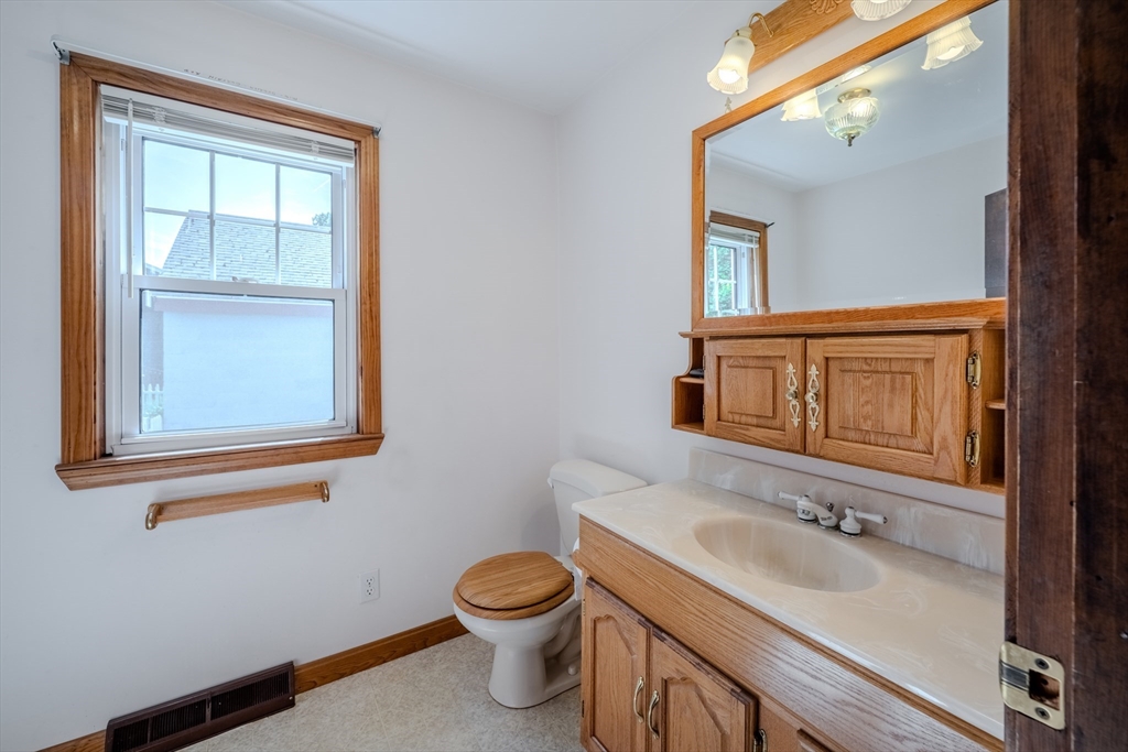 10 Primrose Road Billerica, MA 01821 - Photo 20 of 37 a bathroom with a sink a toilet and mirror