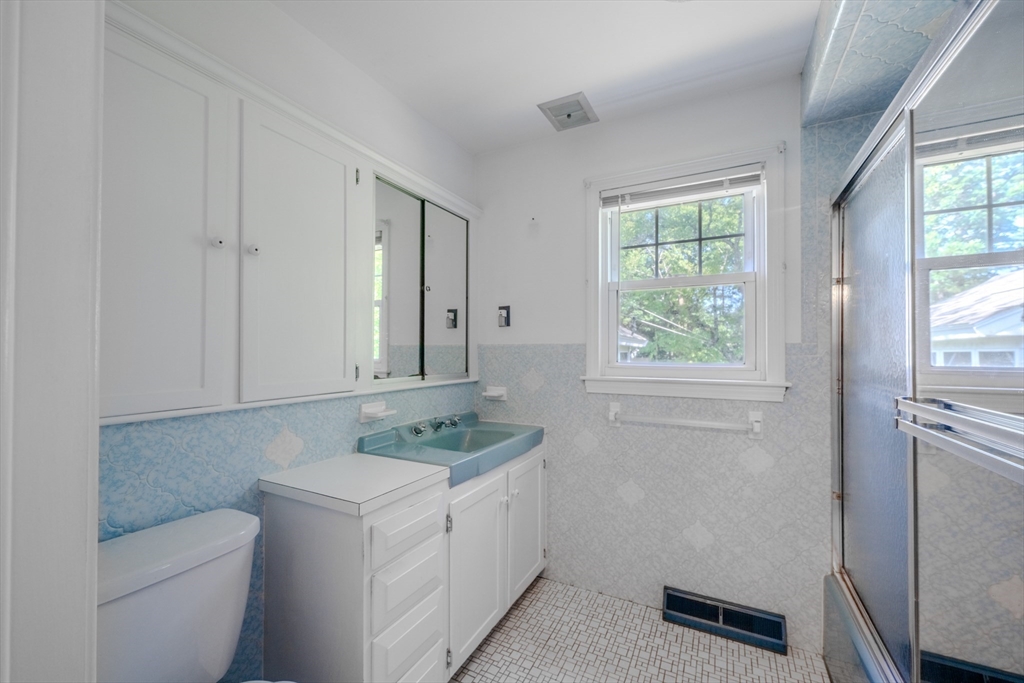 10 Primrose Road Billerica, MA 01821 - Photo 21 of 37 a bathroom with a granite countertop sink and a toilet