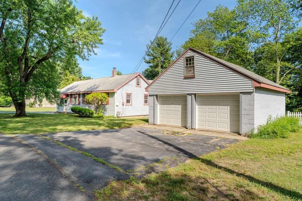10 Primrose Road Billerica, MA 01821 - Photo 4 of 37 a front view of a house with a yard and garage
