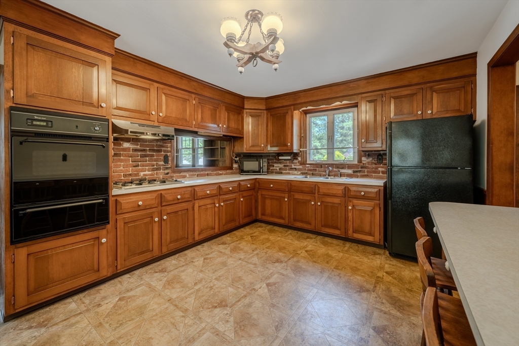 10 Primrose Road Billerica, MA 01821 - Photo 5 of 37 a kitchen with a sink stainless steel appliances and cabinets