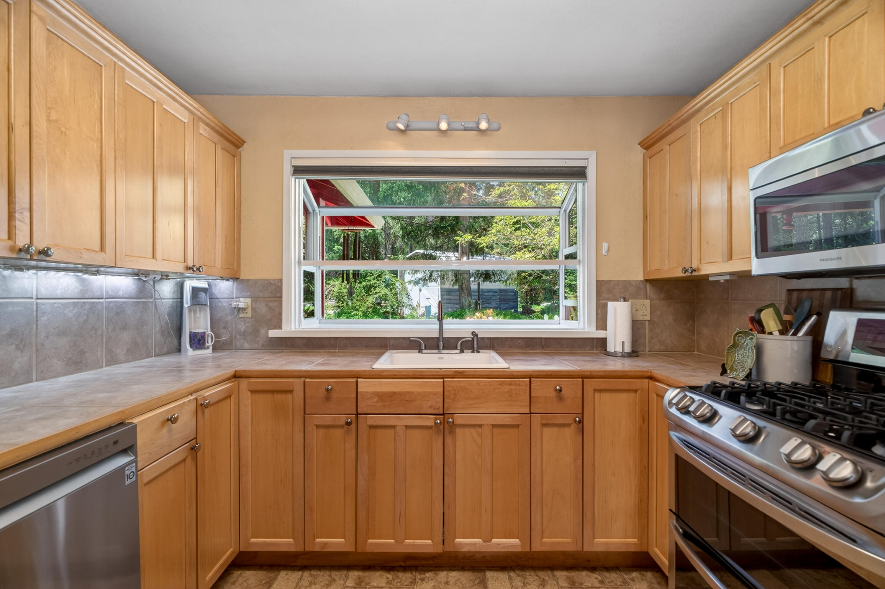 8015 Starlite Pines Road Shingletown, CA 96088 - Photo 12 of 38 a kitchen with wooden cabinets and a stove top oven