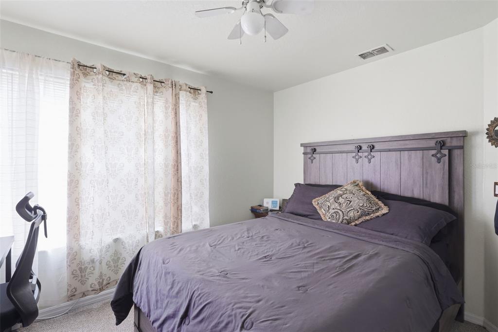 3440 Allston Lane Winter Park, FL 32792 - Photo 13 of 37 a bedroom with a bed and a chandelier