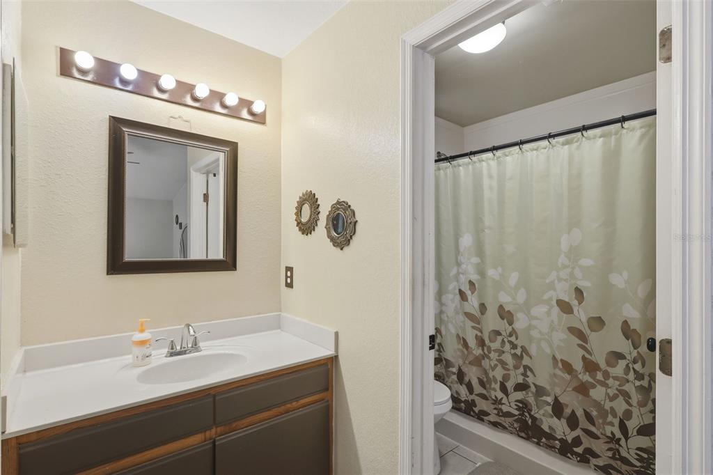 3440 Allston Lane Winter Park, FL 32792 - Photo 16 of 37 a bathroom with a mirror sink and shower