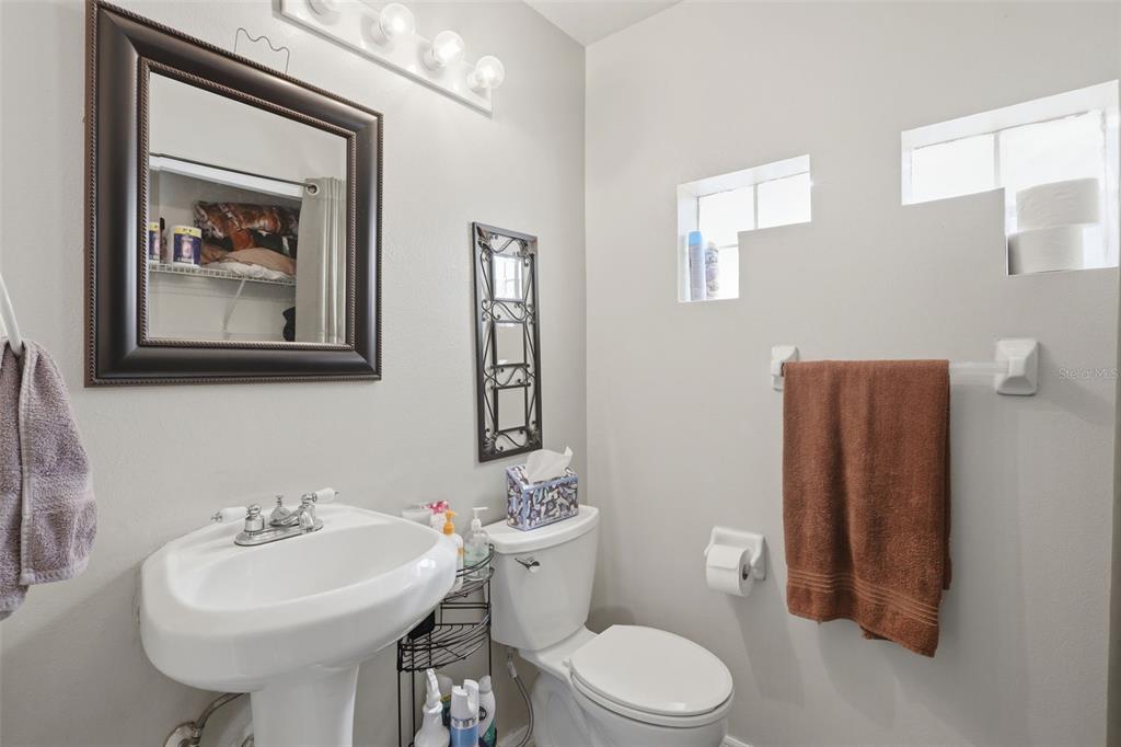3440 Allston Lane Winter Park, FL 32792 - Photo 19 of 37 a bathroom with a toilet a sink and a mirror