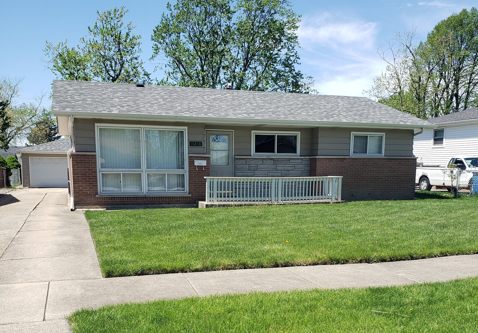 15230 Ridgeway Avenue Midlothian, IL 60445 - Photo 1 of 21 a front view of a house with a yard