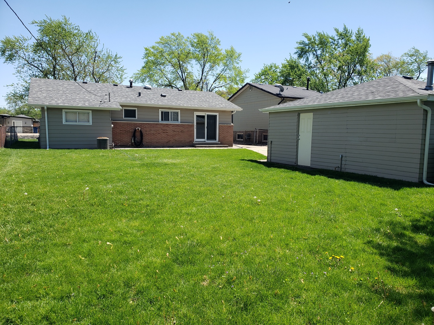 15230 Ridgeway Avenue Midlothian, IL 60445 - Photo 18 of 21 a front view of a house with a garden