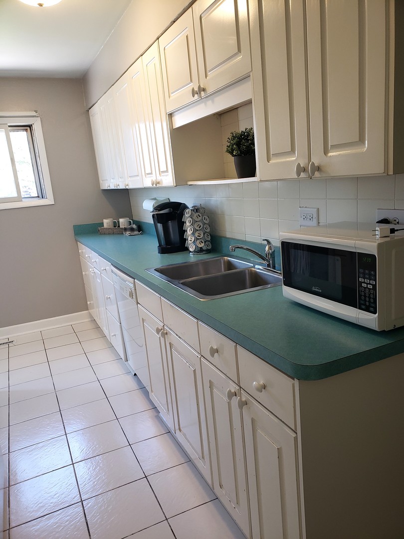 15230 Ridgeway Avenue Midlothian, IL 60445 - Photo 6 of 21 a kitchen with granite countertop white cabinets a sink and dishwasher