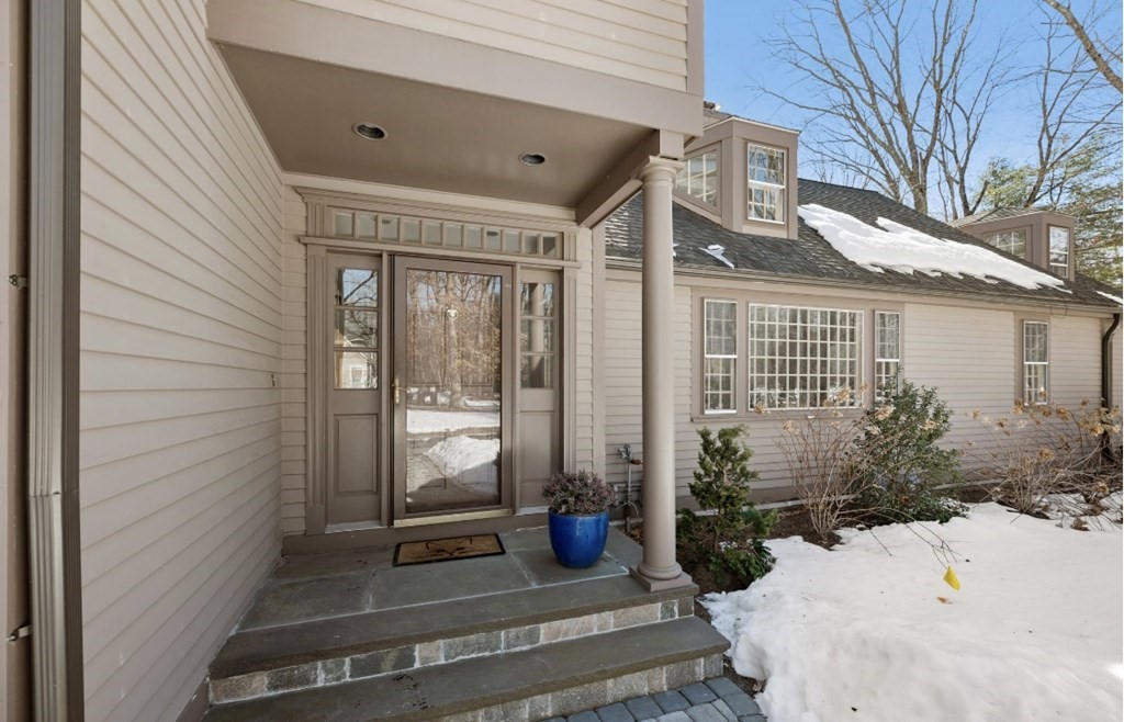30 3 Ponds Road Wayland, MA 01778 - Photo 2 of 28 a view of a patio with table and chairs and potted plants