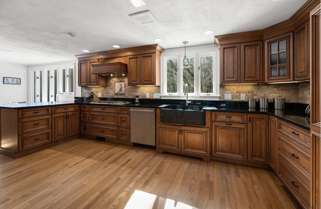 30 3 Ponds Road Wayland, MA 01778 - Photo 8 of 28 a kitchen with stainless steel appliances granite countertop wooden cabinets a sink and dishwasher with wooden floor