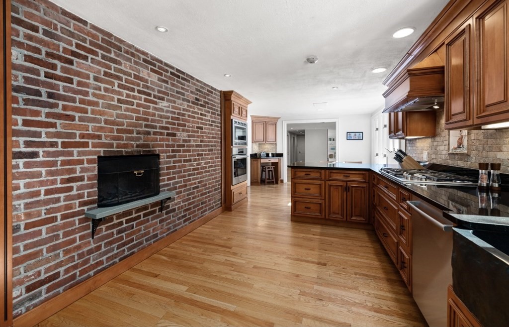 30 3 Ponds Road Wayland, MA 01778 - Photo 9 of 28 a kitchen with stainless steel appliances wooden cabinets and a stove top oven