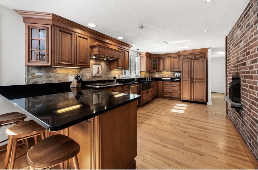 30 3 Ponds Road Wayland, MA 01778 - Photo 10 of 28 a kitchen with a refrigerator stove and sink