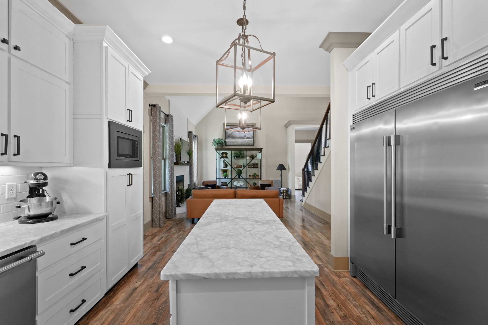 8417 Pine Ridge Road Ooltewah, TN 37363 - Photo 12 of 28 a kitchen with stainless steel appliances granite countertop a refrigerator oven a sink dishwasher and white cabinets with wooden floor