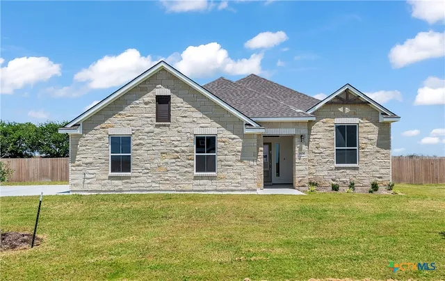 a view of house with backyard