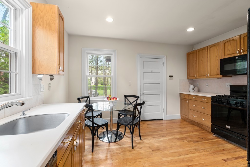 8-10 Upland Road Wellesley, MA 02482 - Photo 17 of 24 a kitchen with a table chairs sink and cabinets