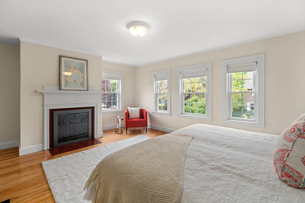 8-10 Upland Road Wellesley, MA 02482 - Photo 19 of 24 a bedroom with a bed and a fireplace