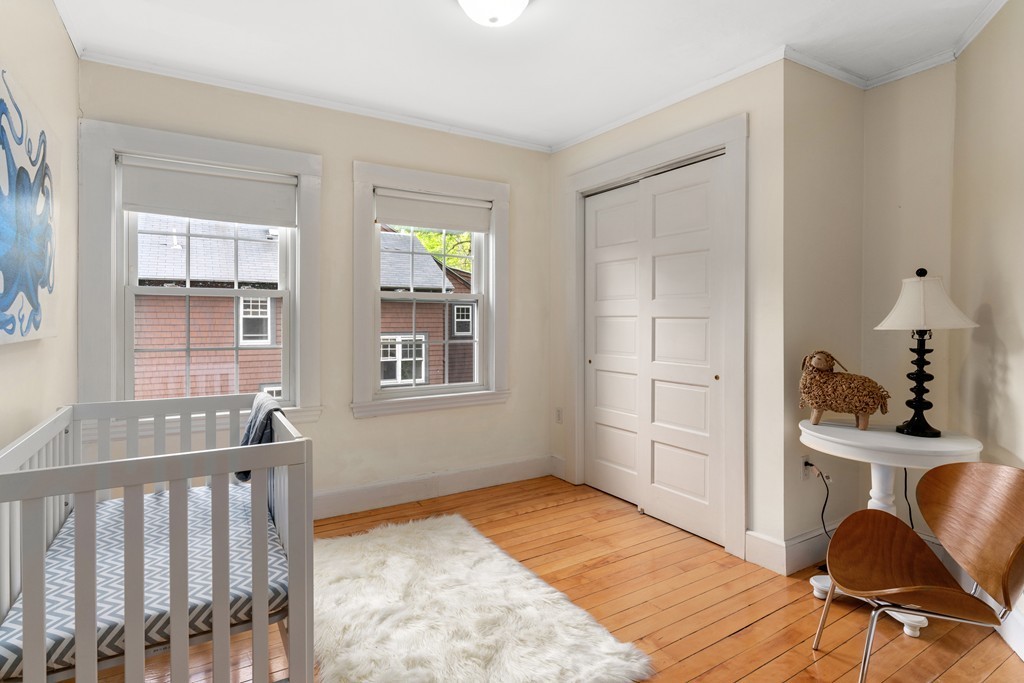 8-10 Upland Road Wellesley, MA 02482 - Photo 22 of 24 a bedroom with furniture and a window