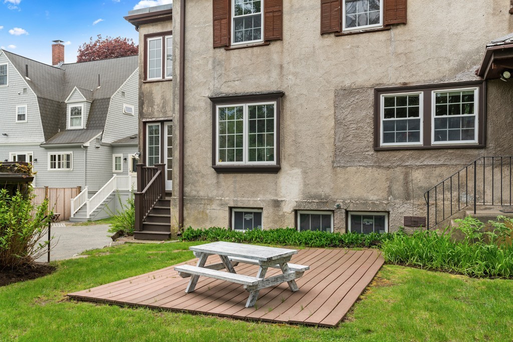 8-10 Upland Road Wellesley, MA 02482 - Photo 23 of 24 a view of a patio with a table and chairs in a patio