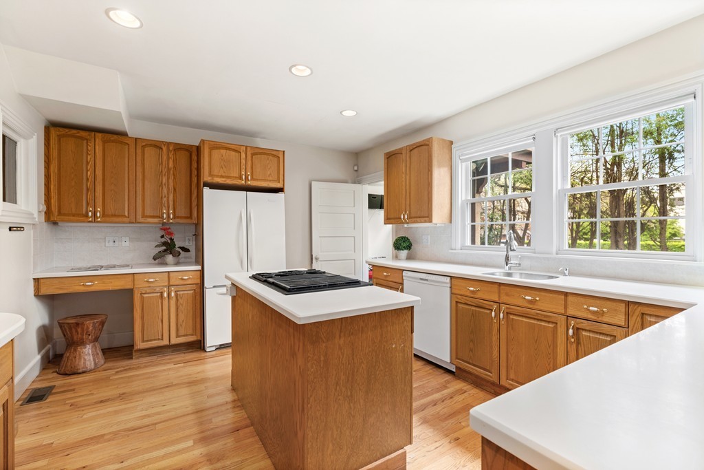 8-10 Upland Road Wellesley, MA 02482 - Photo 8 of 24 a kitchen with a sink stove and wooden cabinets