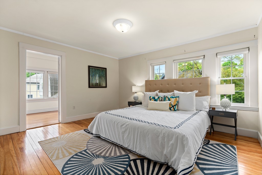 8-10 Upland Road Wellesley, MA 02482 - Photo 9 of 24 a bedroom with a bed and wooden floor