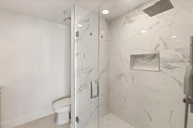 a bathroom with a shower toilet and sink