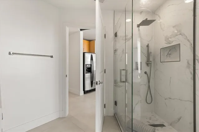 a bathroom with a glass shower door